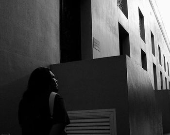 Woman looking at office building