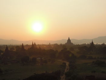 Panoramic view of temple building against sky during sunrise