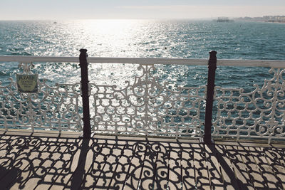 High angle view of railing by sea