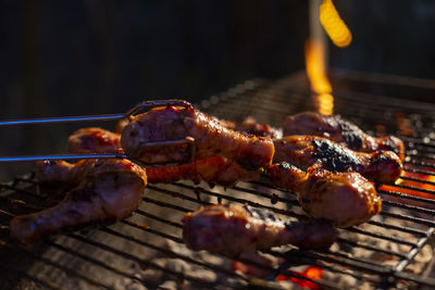 Organic chicken drumsticks are grilled on a barbecue grill. artificial meat