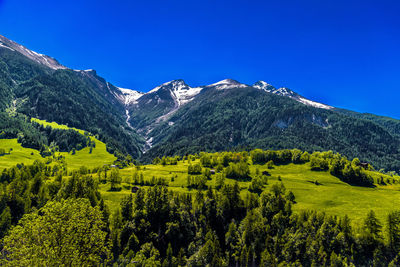 Scenic view of mountains against clear blue sky