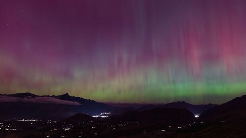 Scenic view of mountains against sky at night