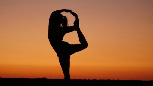 Silhouette man against clear sky during sunset