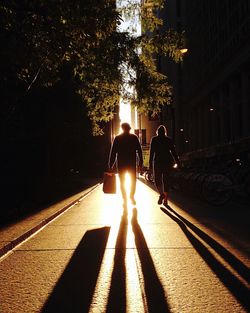 Shadow of people walking on road