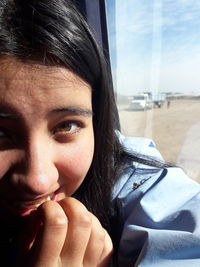 Close-up portrait of young woman in car