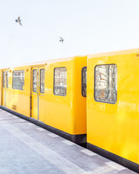 Yellow train against clear sky