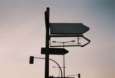 Low angle view of silhouette traffic light against sky at sunset