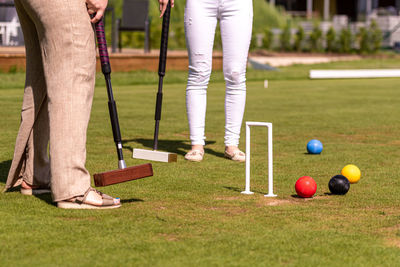 Low section of men playing with ball