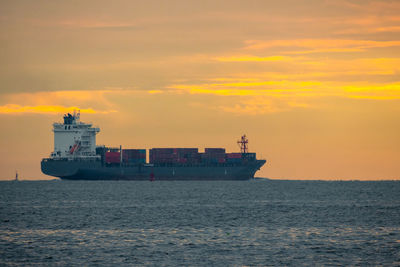 Ship on sea against sky during sunset