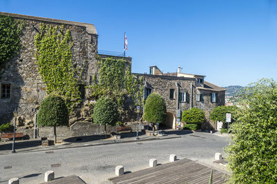 Buildings against clear blue sky in city