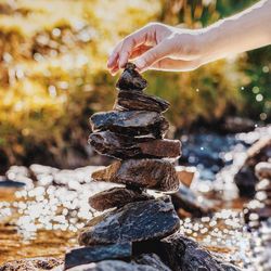 Close-up of person stacking rocks