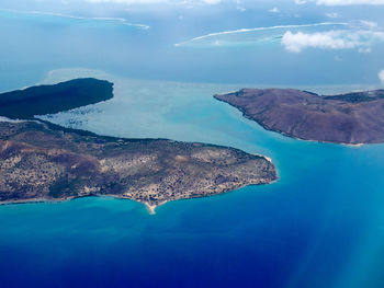 Aerial view of sea and mountains against sky