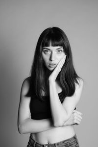 Portrait of beautiful young woman against white background