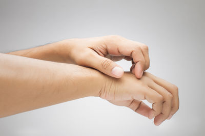 Close-up of woman hand against white background