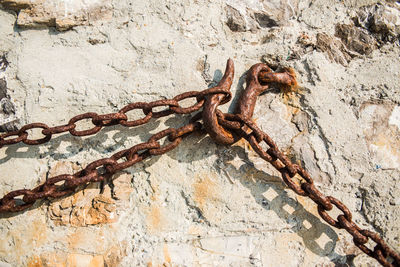 Close-up of rusty chain on wall