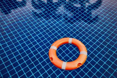 High angle view of life belt floating on swimming pool