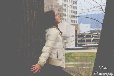 Midsection of woman in city against sky