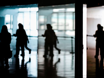 Rear view of people waiting at airport