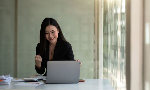 Young woman using laptop at office