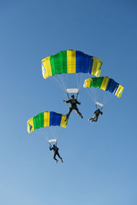 Low angle view of kite flying against clear blue sky