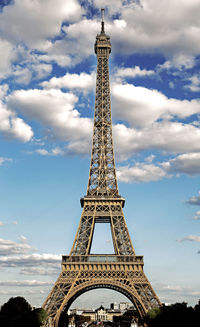 Eiffel tower symbol of the city of paris with hdr effect and the white clouds in the blue sky