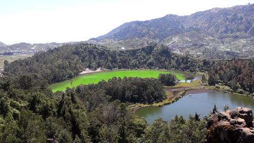 Scenic view of lake and mountains against sky