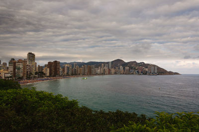 Scenic view of sea and buildings against sky