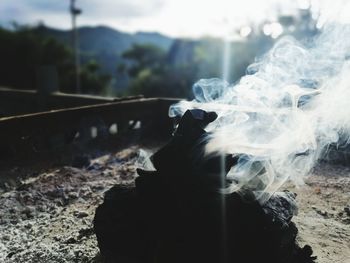 Close-up of smoke emitting from cigarette