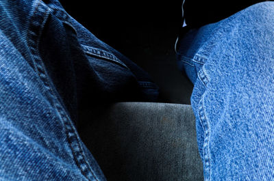 Low section of man sitting on seat