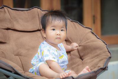 Portrait of cute girl sitting outdoors