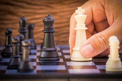 Close-up of hand playing chess 