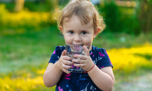 Portrait of cute girl drinking water