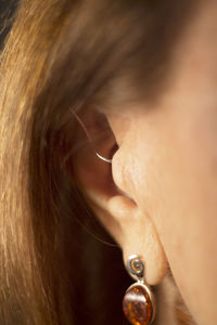 Close-up of woman with hearing aid