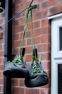 Close-up of shoes hanging on wall