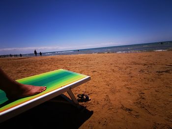 Scenic view of beach against blue sky