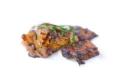 Close-up of meat on white background