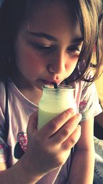 Portrait of cute girl drinking glass