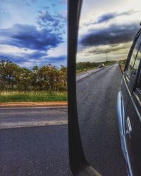 Close-up of car on road against sky