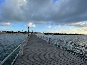 Pier over sea against sky