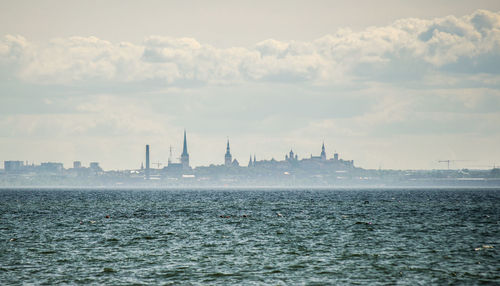 City by sea during foggy weather
