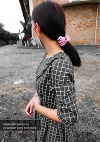 Side view of a girl standing outdoors
