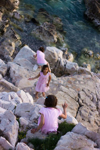 High angle view of women sitting on rock