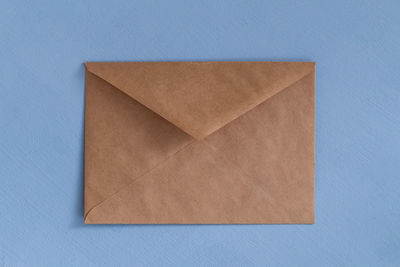 High angle view of paper against blue background