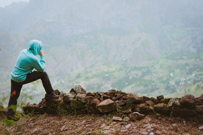 Man standing by rocks