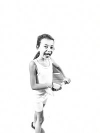 Portrait of smiling girl standing against white background