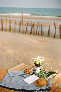 Close-up of stones on beach by sea against sky