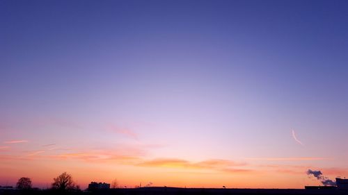 Silhouette trees against sky during sunset