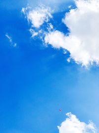 Low angle view of vapor trail against blue sky