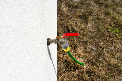 The tap protruding from the wall of the facade in the open position, protected frost during  winter.