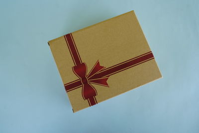 High angle view of gift box on blue background